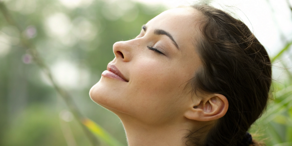 Woman with smooth skin and contoured cheeks showing the natural results of dermal filler.