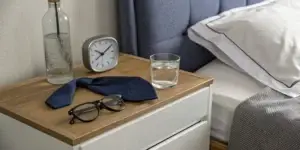A bedside table at night, connecting the feeling of being tired with erectile dysfunction.