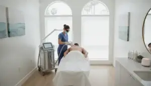 Professional laser hair removal treatment for a man's back in a modern medical aesthetics clinic